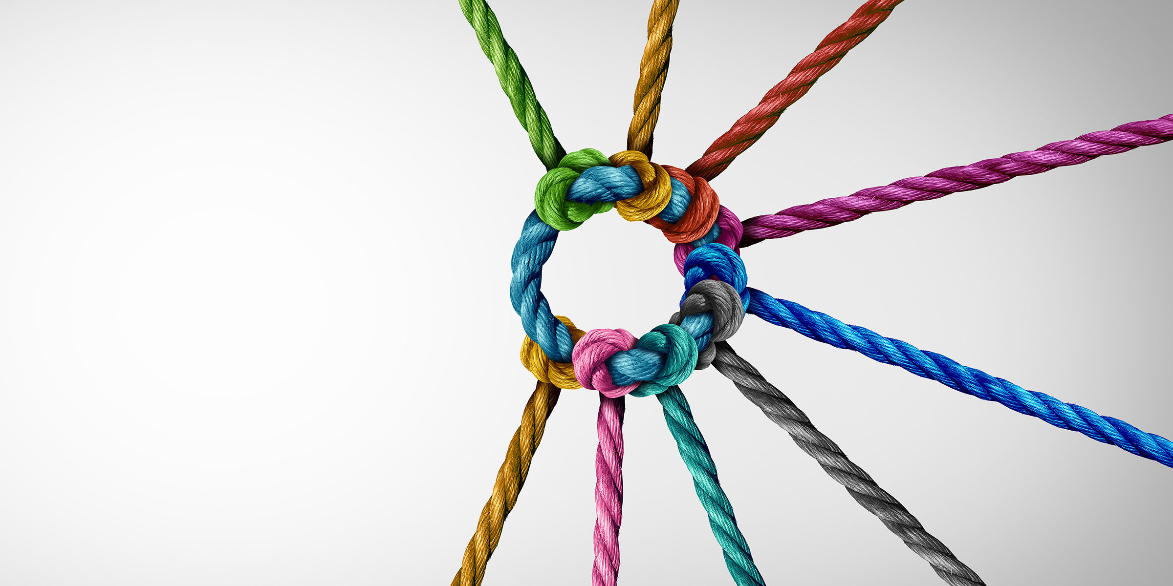 Unity and teamwork concept as a business metaphor for joining a partnership as diverse ropes connected together as a corporate symbol for cooperation and working collaboration.